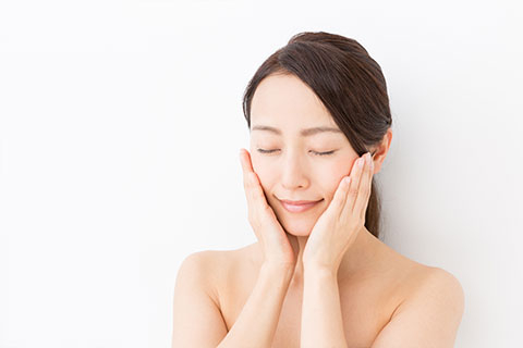 ほほに両手を当てている女性の画像